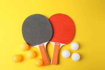 Ping pong racket with the ball for playing table tennis on a colored background