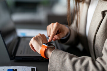 Businesswoman with smartwatch at work