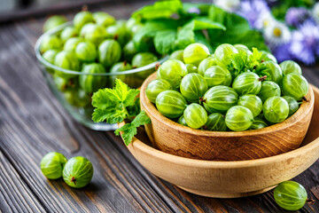 Green Organic Berries Gooseberries.Green gooseberries in a wooden bowl.Gooseberries on the wooden table. Harvest concept. Vegetarian food.