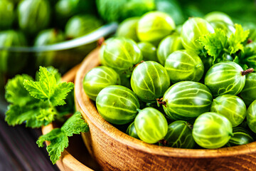 Green Organic Berries Gooseberries.Green gooseberries in a wooden bowl.Gooseberries on the wooden table. Harvest concept. Vegetarian food.