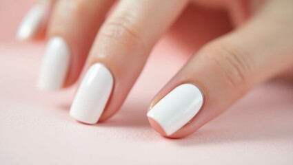Milky White Nails. Close-up white nails manicure on female hand with s