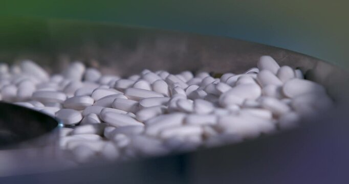 medicine tablets Manufacturing industry close up. machine packaging tablets. equipment sealing tablets in packets. automatic sealing machine in a pharmaceutical manufacturing.	