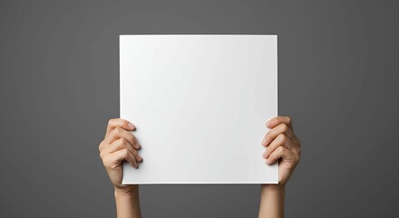Elevated square of pure white cardstock is held by two hands against grey background, emphasizing simplicity and offering customizable message space.