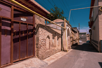 A brick wall with a yellow pipe on it