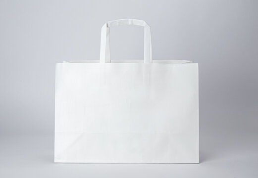 White paper bag with handle isolated on white background