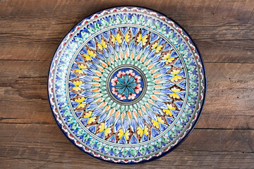 Asian dishes with national ornament on wooden table. Top view.