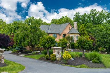 Naklejka premium Luxurious red brick country house for a large family. with a large lawn and landscaping.