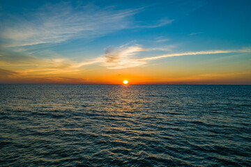 Aerial view sunset sky,Nature beautiful light sunset or sunrise over sea surface,Colorful sunset sky with clouds and waves in the ocean,Wide angle sea background