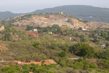 Obraz premium Aerial view of village of yelagiri from the mountain top, a top view, mountains covered with mist. Yelagiri hill station, nearest to Chennai