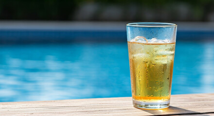 Iced beverage in glass by poolside