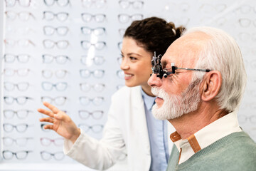 Senior patient checking his eyesight to get new pair of eyeglasses.