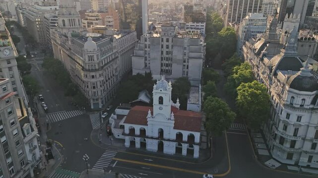 Smooth aerial semi orbit around the historic Cabildo building in downtown Buenos Aires, surrounded by elegant early 1900s architecture and green streets.