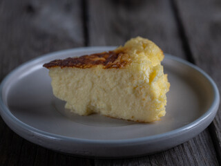 close-up of a slice of La Viña cheesecake on a plate isolated.