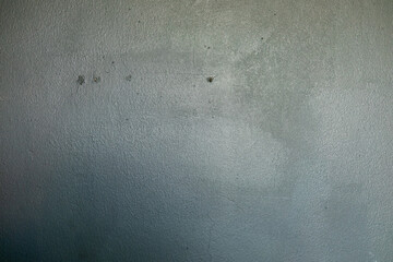 Smooth, slightly textured gray surface with subtle variations in tone and a few small dark spots. Neutral and industrial.