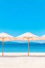 Tranquil beach scene with three white umbrellas on pristine sand, overlooking a calm turquoise sea under a vibrant blue sky