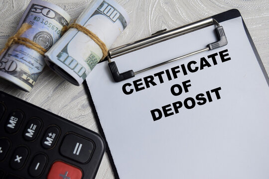 Concept of Certificate of Deposite write on paperwork isolated on Wooden Table.