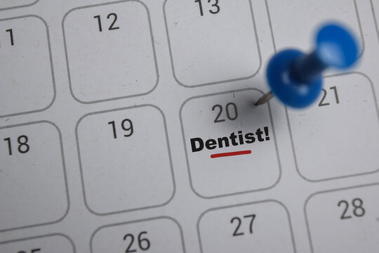20th day of the month. writing text Dentist on calendar date. Save the date. Day of the year concept.