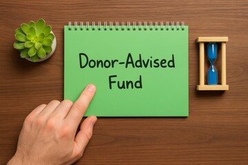 Donor Advised Fund Concept Green Notepad Hand Pointing Time Management Financial Planning Investment Strategy Charitable Giving Philanthropy Donation Tax Deduction Wealth Management Business Finance  