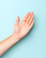 A fair-skinned hand, palm up, extends against a light blue background