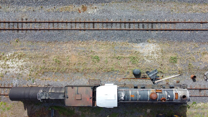 Top-down view of rusted railway track and old steam locomotic
