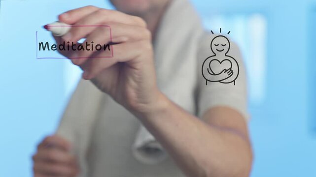 Athlete with a towel around his neck draws a connection between the word meditation and a stylized person hugging a heart, symbolizing self love, on a transparent board against a blue background