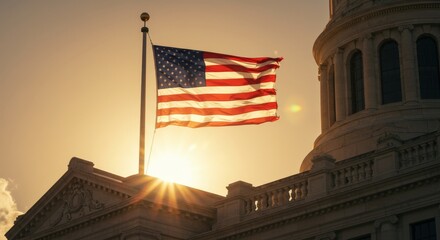 American flag atop a government building silhouetted against a sunset sky