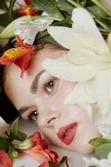 Beautiful girl with natural makeup surrounded by vibrant flowers, capturing a serene and refreshing spring atmosphere with soft colors and gentle emotions © SHOTPRIME STUDIO