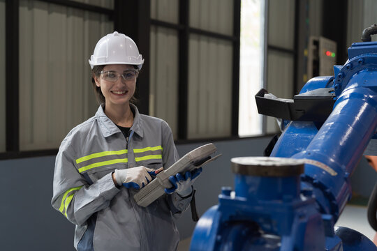 Automatic robotic arm, Storage warehouse. Woman engineer control robotics arms. Installation, testing or setting robotics arms