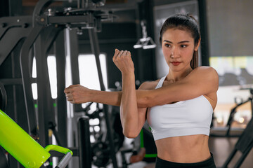 Fototapeta premium Sport woman healthy people exercising in sport club, Gym with strength body building keeping healthy.