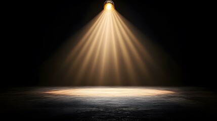 A single spotlight illuminates a dark, textured floor, creating a dramatic, focused beam of light.