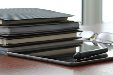 Minimal Office Setup with Books and Tablet