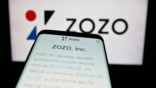 Stuttgart, Germany - 04-25-2025: Mobile phone with webpage of Japanese e-commerce company ZOZO Inc. on screen in front of logo. Focus on top-left of phone display.