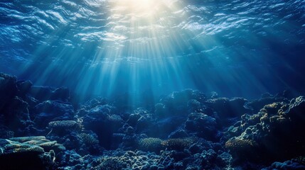 Underwater scene of sunlight beams penetrating coral reef.