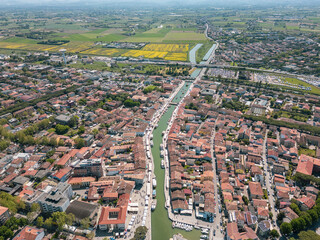 Aerial view of Cesenatico with its port and its canal with historic boats. The town is quiet and...