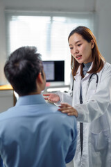 Doctor providing a thorough explanation of the diagnosis while offering comfort by gently touching...