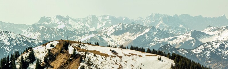 View of the Alpine foothills from Wallberg Mountain
Mountains on the horizon in the morning mist.
Mountain range on the horizon in the morning mist.panoramic photo
