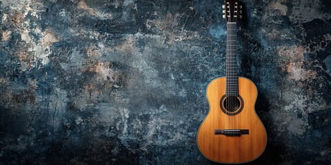 Obraz premium a wooden acoustic guitar in front of a grungy wall 