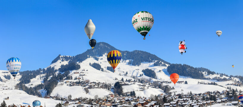 Ch&acirc;teau-d'oex, Switzerland - January 29. 2023: The 43th International Hot Air Balloon Festival from over twenty countries held yearly in the Swiss Alps mountain village Ch&acirc;teau-d'oex.