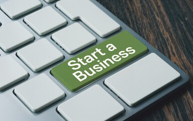 Fototapeta premium Start a business text on a green button in keyboard. Aiming goal or target, startup, development growth concept. 