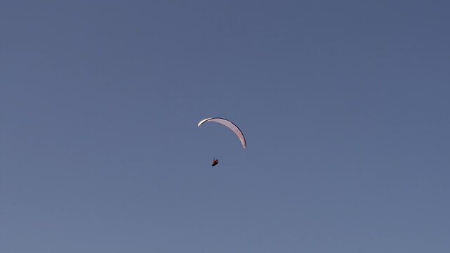 Experience the Thrilling Moments of Paramotoring Under the Vast Clear Blue Sky Above Us