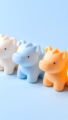 Three cute, cartoon animal figurines lined up on a light blue background