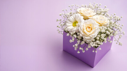 Gift box with beautiful carnation and gypsophila flowers on lilac background. Mother's Day celebration
