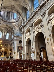 Obraz premium Interior of Église Saint-Paul-Saint-Louis in Paris, showcasing Baroque architecture, soaring arches, chandeliers, and intricate religious art in the historic Le Marais.