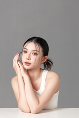 Elegant portrait of a young woman with soft makeup and gentle expression