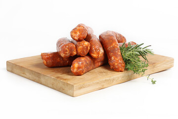 A group of raw merguez sausages arranged on a white background
