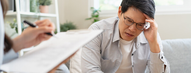 Man talking with mentor psychologist in therapy mental health anxiety session.