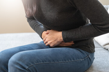 close up woman suffering stomach pain from food poisoning.