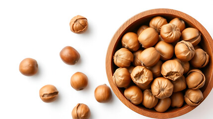 Hazelnuts in the wooden bowl, isolated on the white background, top view.