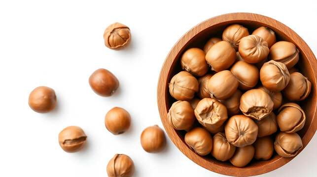 Hazelnuts in the wooden bowl, isolated on the white background, top view.