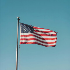 Fototapeta premium U.S. flag flutters against blue sky